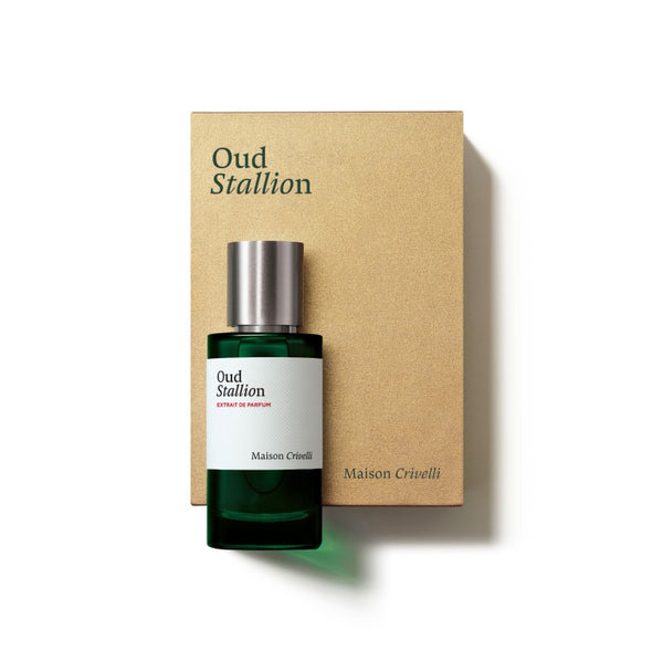 A green bottle of Oud Stallion by Maison Crivelli, placed next to its matching beige box, exemplifies a distinguished leather woody fragrance family.