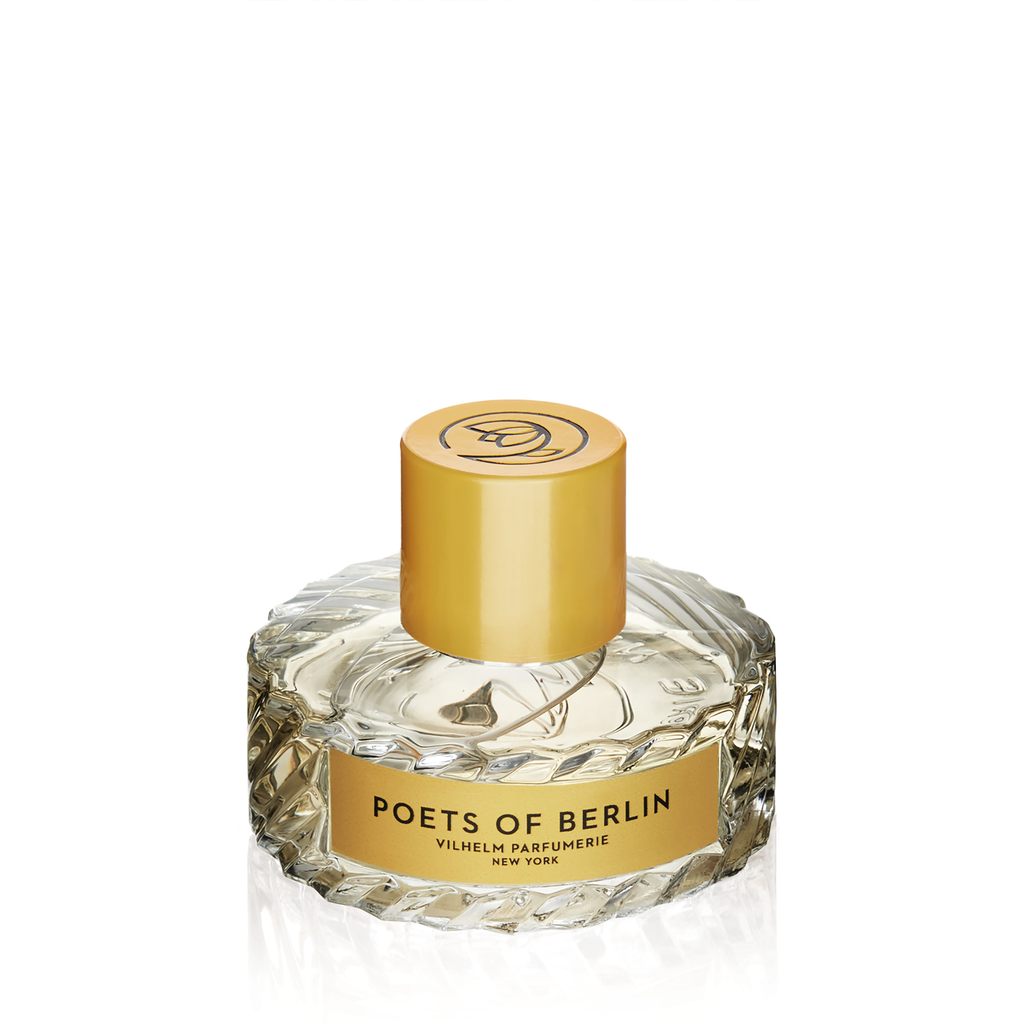 Clear glass perfume bottle with a gold cap and label that reads "Poets of Berlin Vilhelm Parfumerie." The bottle is faceted and filled with a light-colored liquid, hinting at earthy vetiver undertones blended with a subtle touch of blueberry essence.