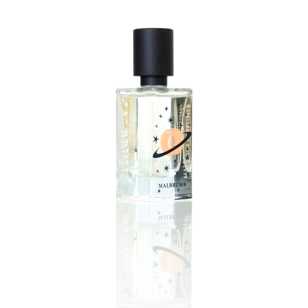 A clear glass perfume bottle with a black cap, adorned with star and planet imagery, is labeled "Malbrum Parfums PARADISO SUPER." This Extrait de Parfum's musky floral scent is as captivating as the celestial design on the bottle, beautifully reflected on the surface it rests upon.