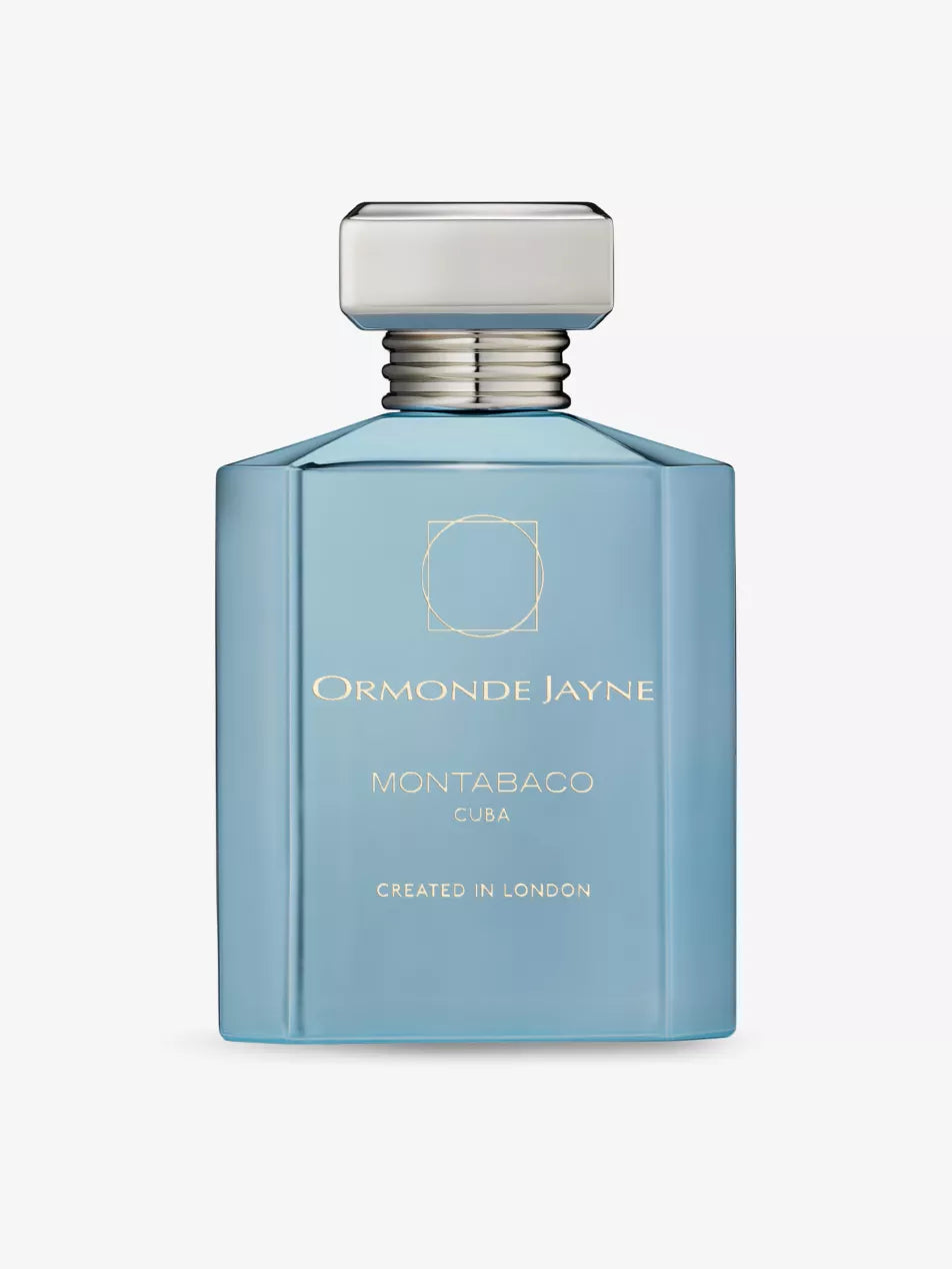 A blue rectangular perfume bottle labeled "Montabaco Cuba" with a silver cap and the text "Created in London," exuding a Cuba fragrance with hints of tobacco leaves.