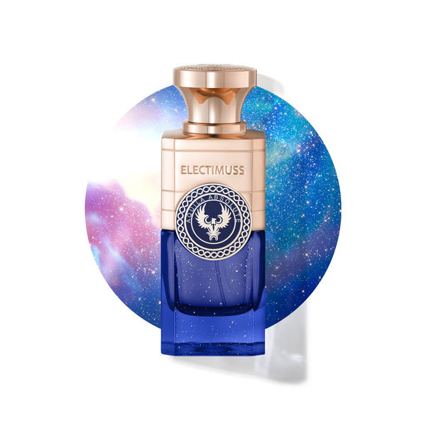 A bottle of Electimuss Aquila Absolute with a blue and gold design is set against a circular galaxy background, capturing the bright, fresh, fruity essence crafted by master perfumer Julien Rasquinet.