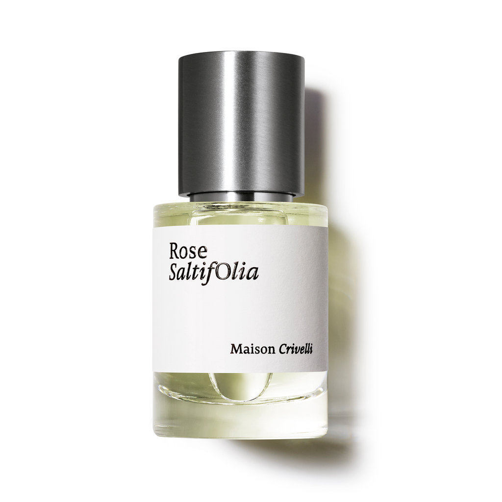 A bottle of perfume named "Rose Saltifolia" by Maison Crivelli, adorned with a silver cap and white label, exudes an exquisite floral marine essence with delicate hints of rose Centifolia.