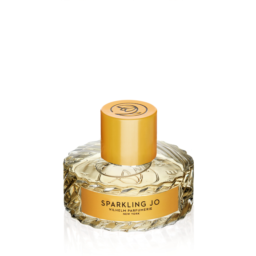 A bottle of Vilhelm Parfumerie's "Sparkling Jo" perfume, crafted by a Master Perfumer, boasts an elegant ribbed glass design and a sophisticated gold cap and label.