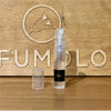 A 2ml spray vial with a clear cap is placed on a wooden surface, featuring a logo with a bird and the word "PERFUMOLOGY" engraved in the background, radiating the rich aroma of honey from Zoologist Bee.