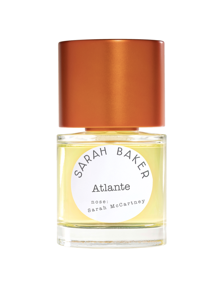 A bottle of Sarah Baker's fragrance "Atlante" featuring a distinctive amber-colored cap. The label prominently displays "Sarah Baker" and "Atlante," with the inscription "nose: Sarah McCartney" below, offering a fresh scent evocative of seaweed.