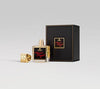 A square bottle of Secret Tryst by Fragrance Du Bois, featuring a gold cap, sits beside a matching black and gold textured box, embodying its allure.