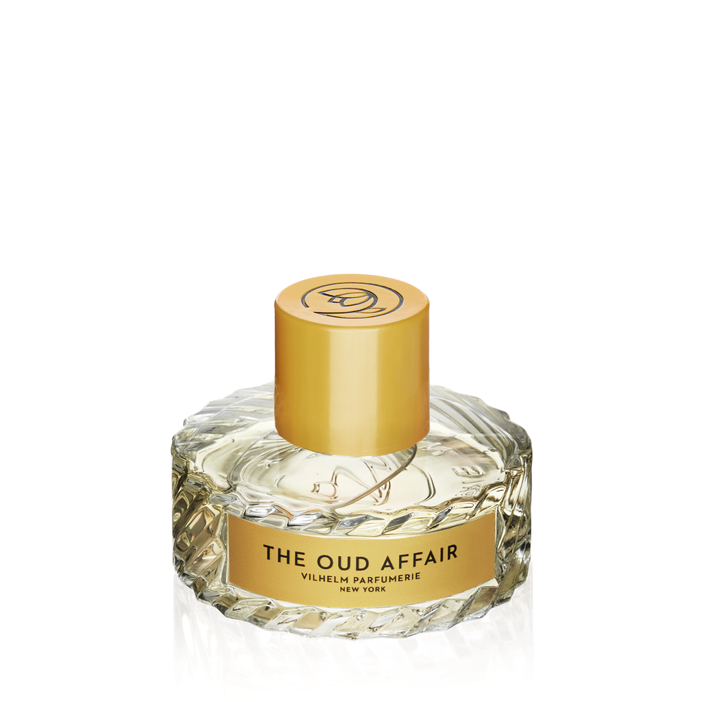A clear, textured glass bottle with a gold cap, labelled "The Oud Affair, Vilhelm Parfumerie," evokes a rich aroma of wild honey and tobacco leaves.