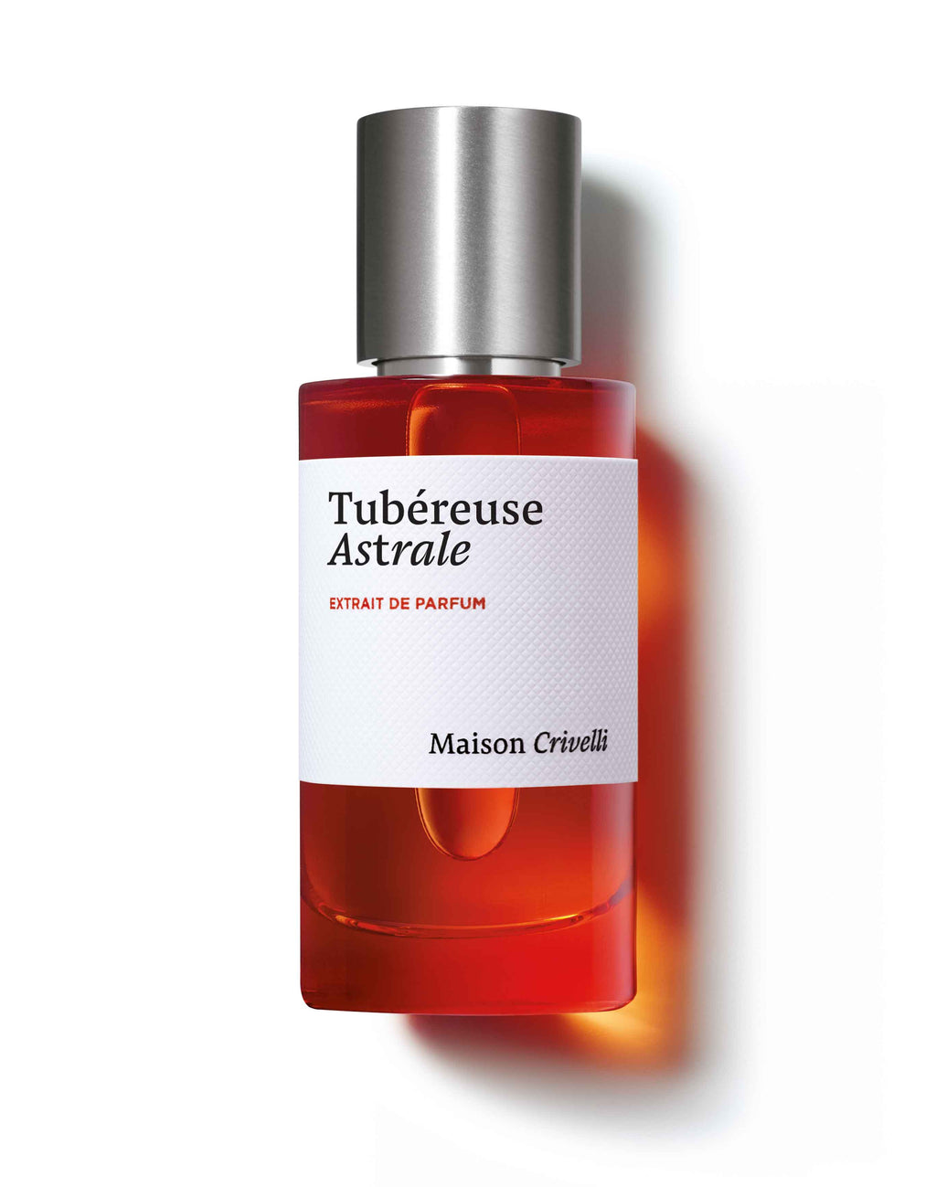 A bottle of Tubéreuse Astrale by Maison Crivelli, masterfully crafted by Quentin Bisch, featuring an orange hue and a metallic cap.