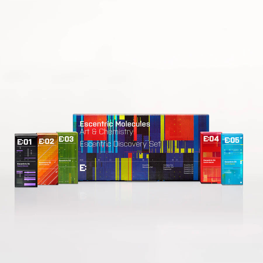 A vibrant Escentric 2ml Discovery Set from Escentric Molecules, featuring gender-free perfumes E:01 to E:05, is displayed in front of a multicolored packaging box.
