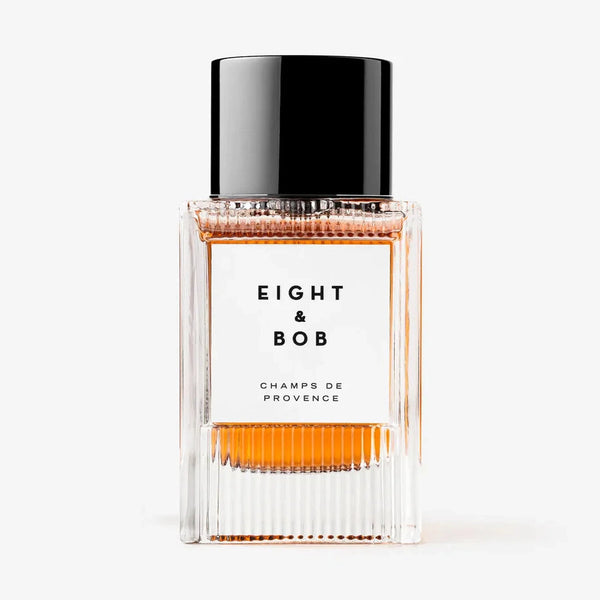 Champs de Provence fragrance bottle, clear glass with orange liquid and black cap