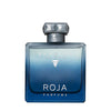 A blue gradient bottle of Roja Parfums' Elysium Eau Intense, featuring a diamond-shaped cap and the brand logo in silver, captures the essence of a fresh woody sensual fragrance.