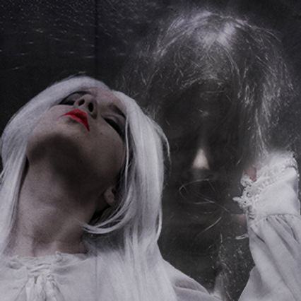 A person with white hair and red lips tilts their head back, the enchanting scent of Ikiryo's M'Oud Enhancer lingering in the air as a faint ghostly figure emerges in the background.