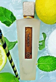 A frosted bottle of Antonio Alessandria's Fara fragrance is surrounded by a lemon, mint leaves, and a striped stick, all set against a light green background, highlighting its refreshing citrus mint scent.