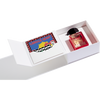 A white rectangular box containing a bottle of Jusbox Carioca Heart perfume with a fruity, woody, musky aroma and a colorful card inside a sleeve.