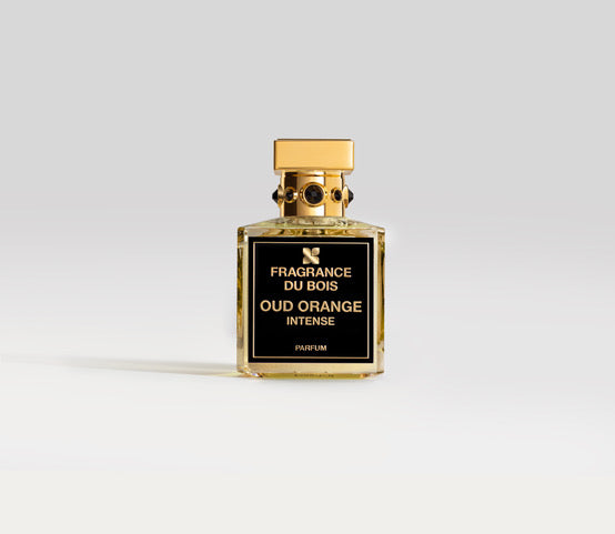 A square bottle of Fragrance Du Bois' Oud Orange Intense parfum, featuring a stylish black and gold label and topped with a gold cap, stands elegantly against a light gray background, emanating the unique charm of Organic Vintage Oud.