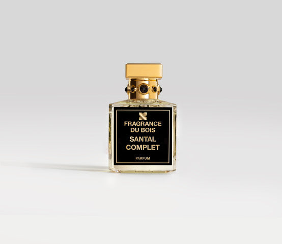 A bottle of Fragrance Du Bois Santal Complet, showcasing a black and gold label with a shiny gold cap, crafted by Master Perfumers, and featuring an exquisite hint of coconut fragrance.