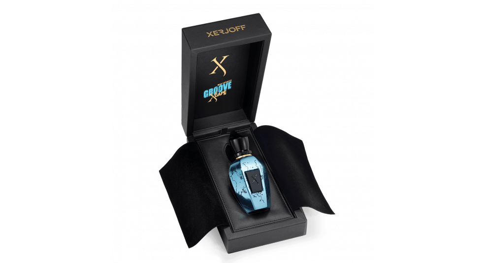 A Groove Xcape fragrance bottle by Xerjoff, designed in blue and crafted with precious ingredients, is displayed in an open black box adorned with gold text.