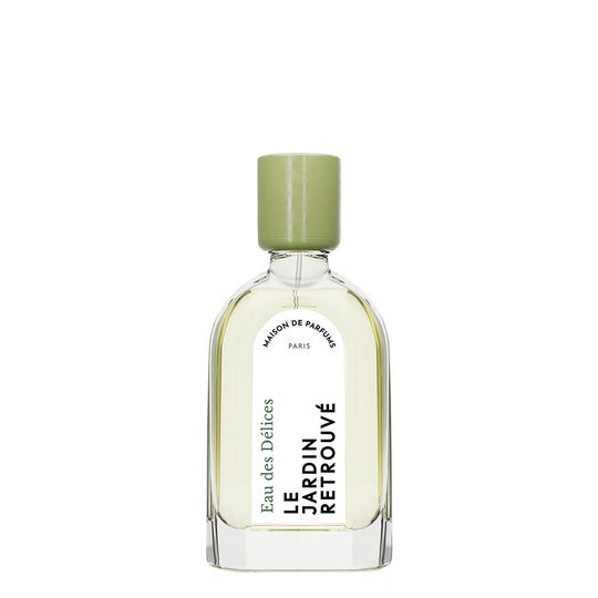 An elegant clear glass bottle of Le Jardin Retrouvé Eau des Délices citrus perfume, featuring a green cap and a white label with the brand name and details elegantly printed in black text. This invigorating unisex scent captures the essence of an Eau Fraiche experience.