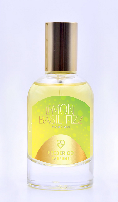 A bottle of Frederico Parfums' Lemon Basil Fizz Parfum, featuring a gold cap and a green and yellow label, captures the essence of a citrus cocktail with subtle notes of basil and lavender.