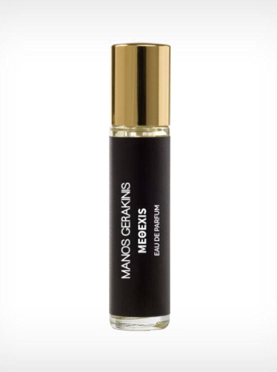 A black and gold cylindrical perfume bottle with the label "Manos Gerakinis - METHEXIS - Eau De Parfum," this luxurious fragrance features a captivating fig scent and is crafted with plant-based alcohol.