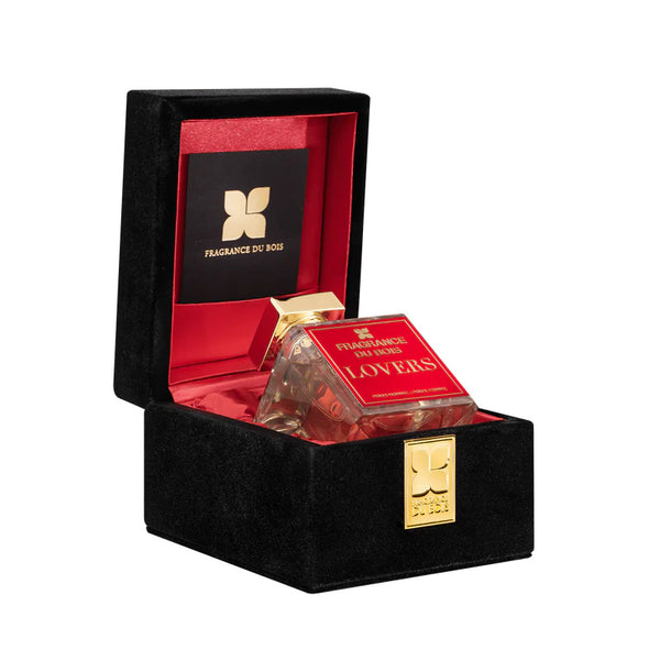 A Fragrance du Bois "LOVERS" perfume bottle is showcased in an open black and red velvet-lined box, featuring an aromatic aphrodisiac Extrait De Parfum.