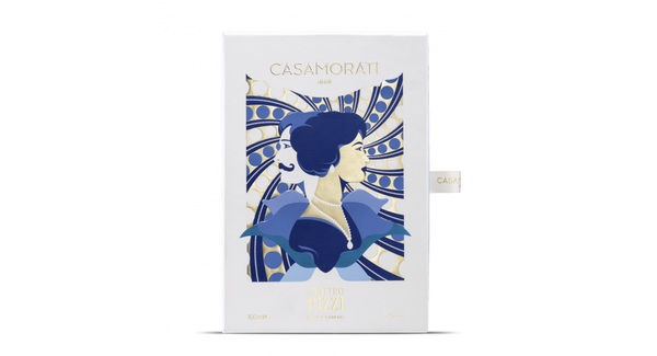 A perfume box with intricate blue and gold artwork featuring a profile of a woman in an elegant dress. The brand name "Casamorati" and the perfume name "Quattro Pizzi" are displayed on the box, showcasing its exquisite olfactory notes.