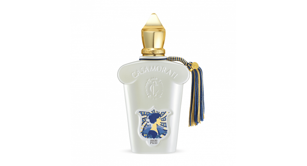 A white perfume bottle with a gold cap and blue tassel. The bottle displays the Casamorati label and a blue emblem featuring a black horse and rider, capturing the essence of Quattro Pizzi by Casamorati with its exquisite olfactory notes, perfect for a summer scent.