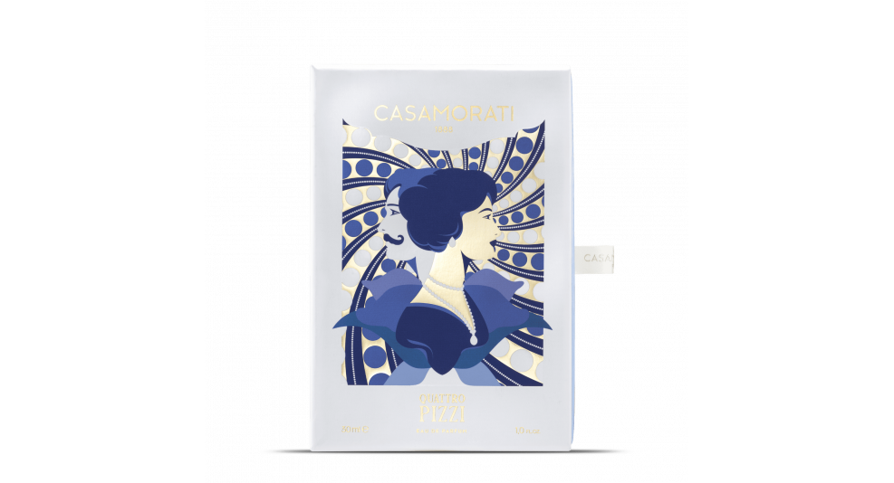 A rectangular white packaging features an artistic illustration of a woman with short dark hair in a vintage style, set against a blue and gold patterned background, labeled "Casamorati Quattro Pizzi." The design evokes the summer scent’s olfactory notes.