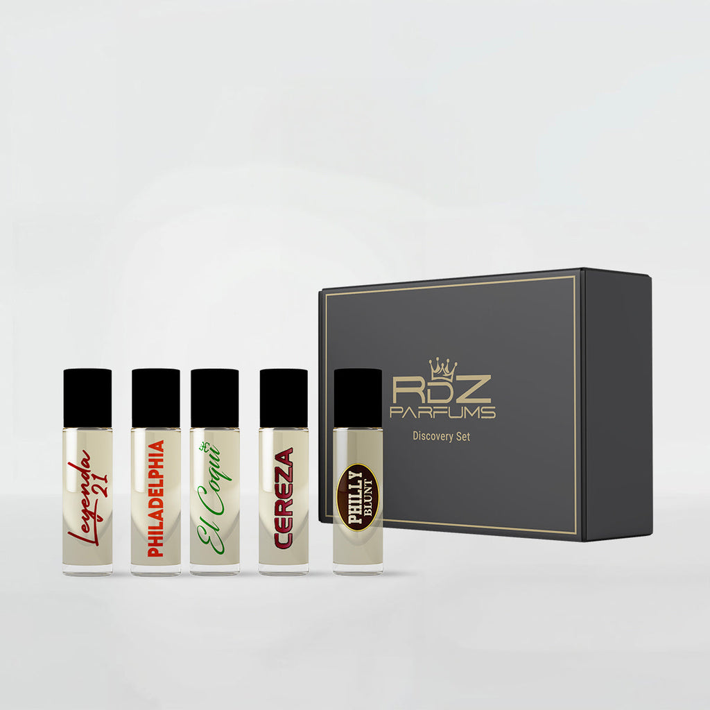 The RDZ Parfums Discovery Set 5 x 3ml features five small perfume bottles, each labeled with unique scents: "Lovers' Lane," "Philadelphia," "El Capitan," "Cereza," and "Philly Philly." These are displayed in front of a black box with the text "RDZ Parfums Discovery Set" and offer a distinctive fragrance experience.