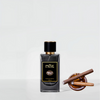 A bottle of "PHILLY Blunt" extrait de parfum by RDZ Parfums with a black and gold label sits next to an open wooden container holding two rolled cigars, evoking a sweet tobacco aroma that resonates with urban culture.