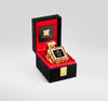 A fragrance bottle with a gold cap and black label displayed in a black and red velvet-lined box, crafted by master perfumer Francois Merle-Baudoin, offering the essence of London's masculine spice. London Spice by Fragrance du Bois.