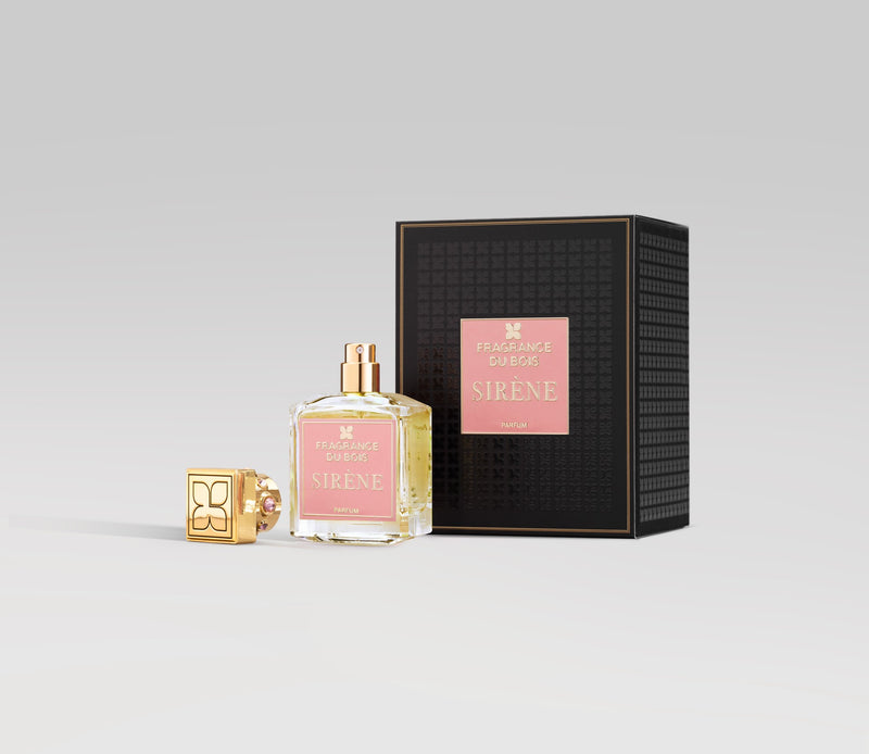 A bottle of SIRÈNE perfume with a removed gold cap is placed next to its black and gold packaging box. The label and box both display "Fragrance Du Bois" and "SIRÈNE," highlighting this female-inspired fragrance known for its seductive burst of cherries.