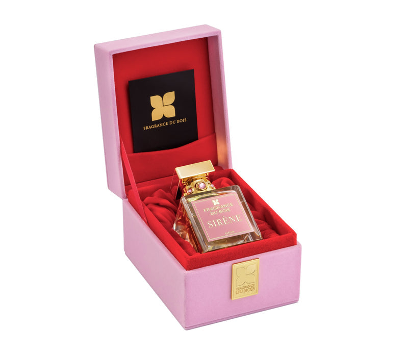 Open pink box with red interior, containing a bottle of SIRÈNE by Fragrance Du Bois, a female-inspired fragrance known for its seductive burst of cherries, and a black square card with a gold logo.