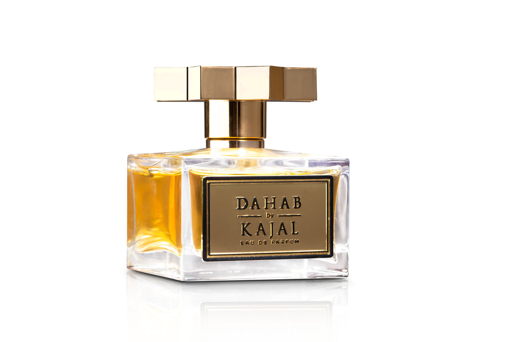 A square glass bottle of Dahab from the Kajal - Classic Collection Eau de Parfum features a golden cap and a labelled front. This 100ml EDP holds a golden-hued liquid, delivering an opulent fragrance.