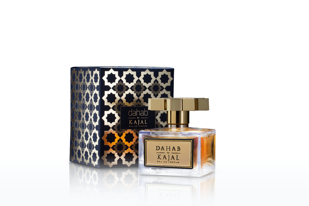 A bottle of Dahab by Kajal - Classic Collection Eau de Parfum is positioned in front of its decorative, patterned box. The luxurious fragrance comes in a 100ml EDP bottle featuring a gold cap and label, with both the bottle and the box elegantly displaying the product name "Dahab.