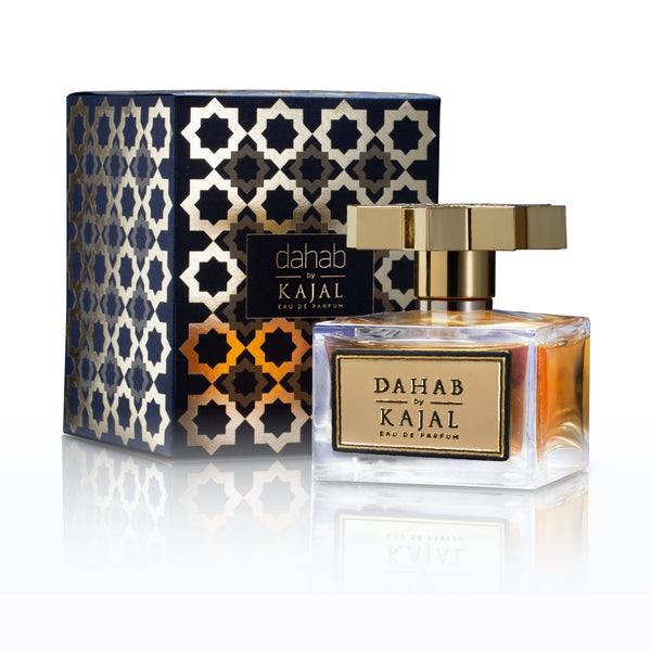 A bottle of Dahab by Kajal - Classic Collection Eau de Parfum is positioned in front of its decorative, patterned box. The luxurious fragrance comes in a 100ml EDP bottle featuring a gold cap and label, with both the bottle and the box elegantly displaying the product name "Dahab.