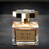 A clear glass perfume bottle with a gold and black star-shaped cap stands elegantly. The label reads "Dahab by Kajal - Classic Collection Eau de Parfum." This luxurious fragrance, in a 100ml EDP bottle, is placed on a dark, textured surface.