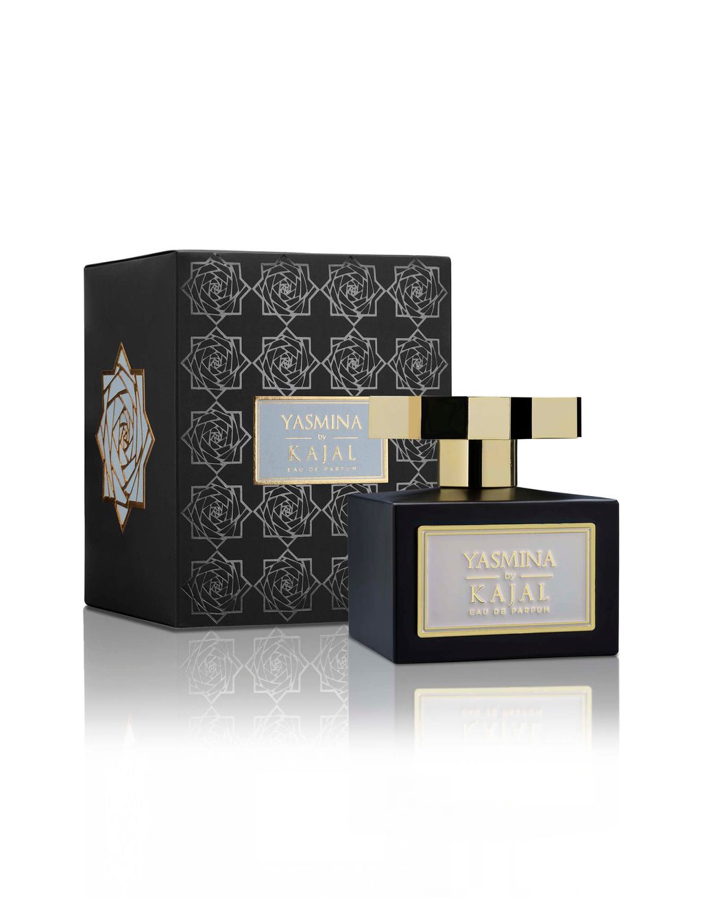 A black perfume bottle labeled "Yasmina" from the Kajal - Wardé Collection is placed in front of its matching box, which is adorned with geometric patterns and a rose graphic, reflecting the delicate strength of jasmine woven into its scent.