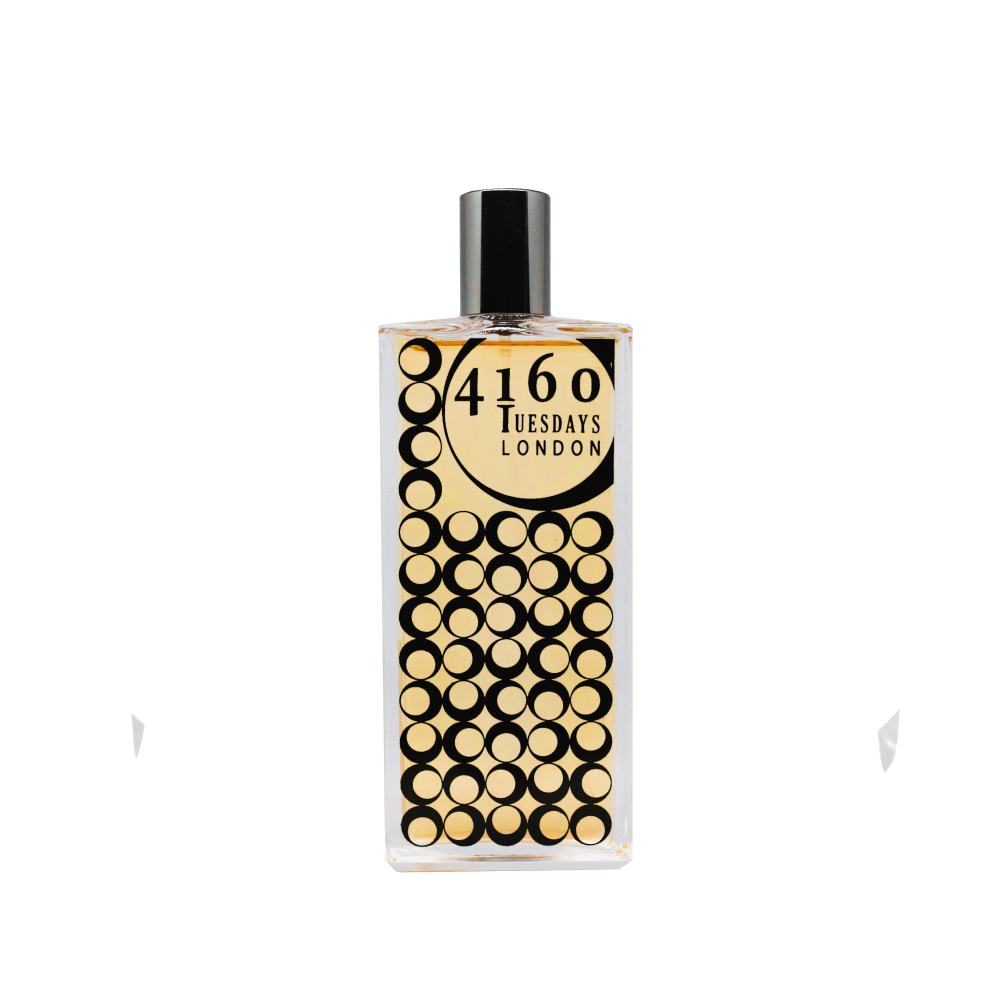 A rectangular bottle with a black cap, featuring the label "4160Tuesdays" and a design of concentric circles in black and gold, evokes the comforting aroma of wholemeal lemon and ginger biscuits.