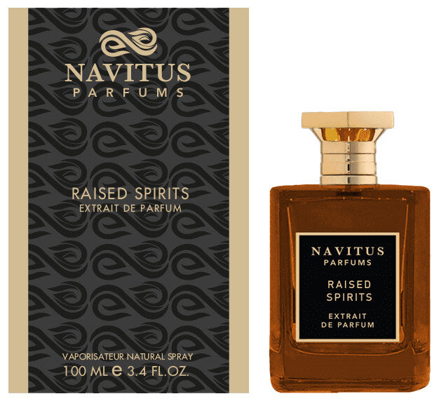 Navitus Parfums Raised Spirits bottle, an extrait de parfum with a rich amber hue and adorned with a gold cap, sits next to its elegantly dark-patterned box. Suggesting hints of dark rum and Madagascar vanilla, the 100ml (3.4 fl. oz.) fragrance is beautifully labeled with golden text.
