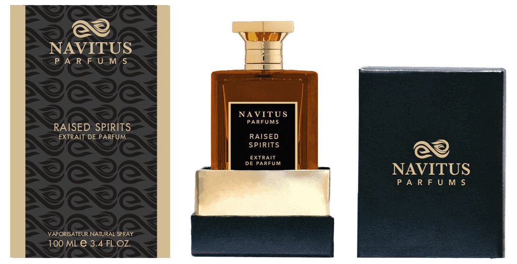 A 100 ml bottle of Navitus Parfums' Raised Spirits Extrait de Parfum, infused with dark rum and Madagascar vanilla notes, is showcased between its decorative outer packaging and an open box with the bottle partially mounted.
