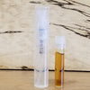 Tall clear sample vial and small vial with amber liquid in holders