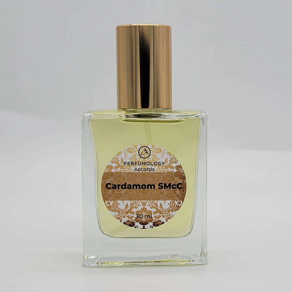 A 30 ml bottle of perfume labeled "Cardamom SMcC" by Perfumology Accords, with a gold cap and containing yellow liquid, crafted by Sarah McCartney of 4160 Tuesdays.