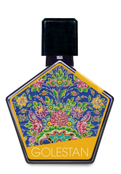 A hexagonal bottle of Tauer Perfumes' Golestan floral perfume, with a label adorned in vibrant floral patterns set against a blue background, capturing the essence of white flower absolutes. The bottle is topped with a black cap.
