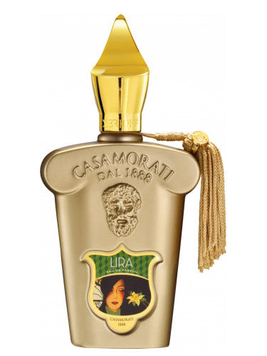 Gold bottle of Casamorati Lira perfume with a decorative cap and tassel, featuring a label with an illustrated woman's face. Inspired by vintage fragrances, its luxurious scent captures the essence of Italian perfumery with hints of caramel and vanilla.