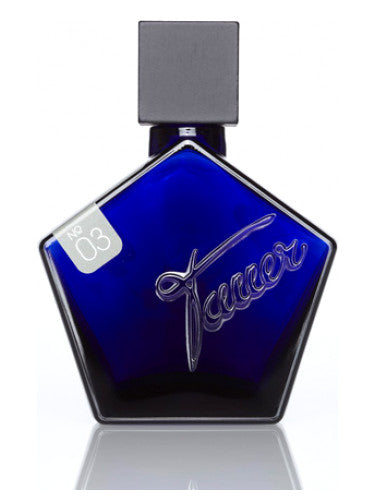 A blue pentagonal perfume bottle bearing the word "Tauer" embossed on it and "No 03" on a small label near the top, Lonestar Memories by Tauer Perfumes exudes an intrigue of Birchtar and hints of smoky fire.