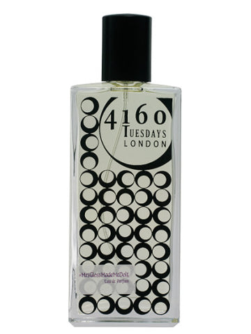 A rectangular glass bottle of 4160Tuesdays #MrsGlossMadeMeDoIt perfume featuring a pattern of black circles and a rectangular label.