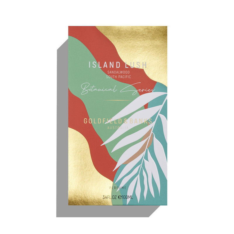 Image of a perfume box labeled "Island Lush" by Goldfield & Banks. The design features abstract colorful shapes and white leaves on a gold, green, and red background, evoking the exotic fragrance of South Pacific Sandalwood.