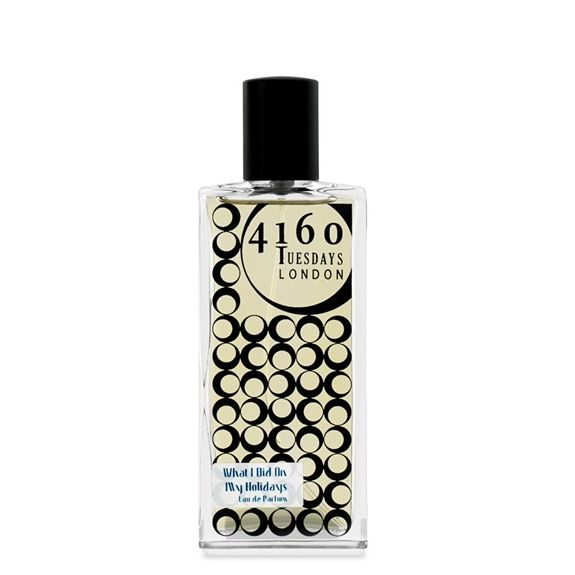 A rectangular perfume bottle with a black cap. The label showcases "4160Tuesdays London" along with a pattern of black circles and the phrase "What I Did on My Holidays Eau de Parfum" at the bottom, featuring notes of mint and candy floss from one of our best-selling scents.
