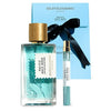 A set of "Pacific Rock Moss" perfume by Goldfield & Banks. This fresh perfume includes a large bottle, a travel size spray, and a blue box with a black ribbon – perfect for capturing the essence of beach life.